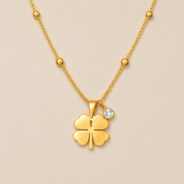 NAMIKA lucky four leaf clover necklace for women featuring a gold stainless steel clover pendant with crystal charm, anti tarnish, waterproof, hypoallergenic minimalist everyday jewellery.