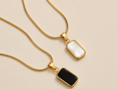 NAMIKA reversible black and white pendant necklace for women featuring a gold stainless steel two sided pendant with black and white enamel finish, anti tarnish, waterproof and hypoallergenic.