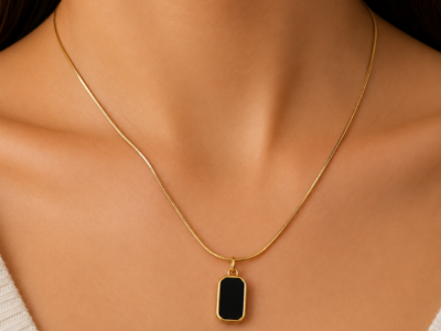NAMIKA reversible black and white pendant necklace for women featuring a gold stainless steel two sided pendant with black and white enamel finish, anti tarnish, waterproof and hypoallergenic.